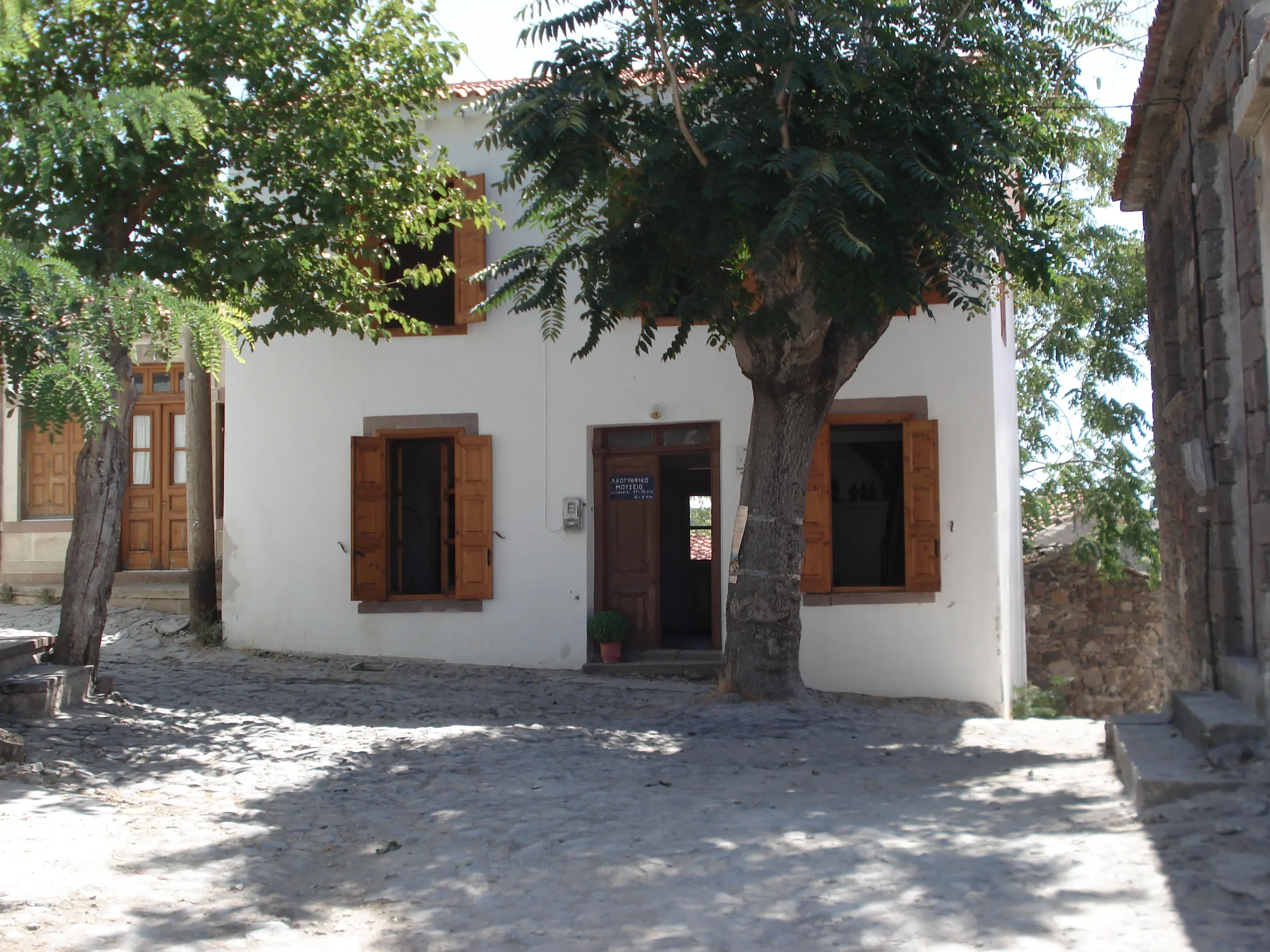 Small white house with wooden shutters