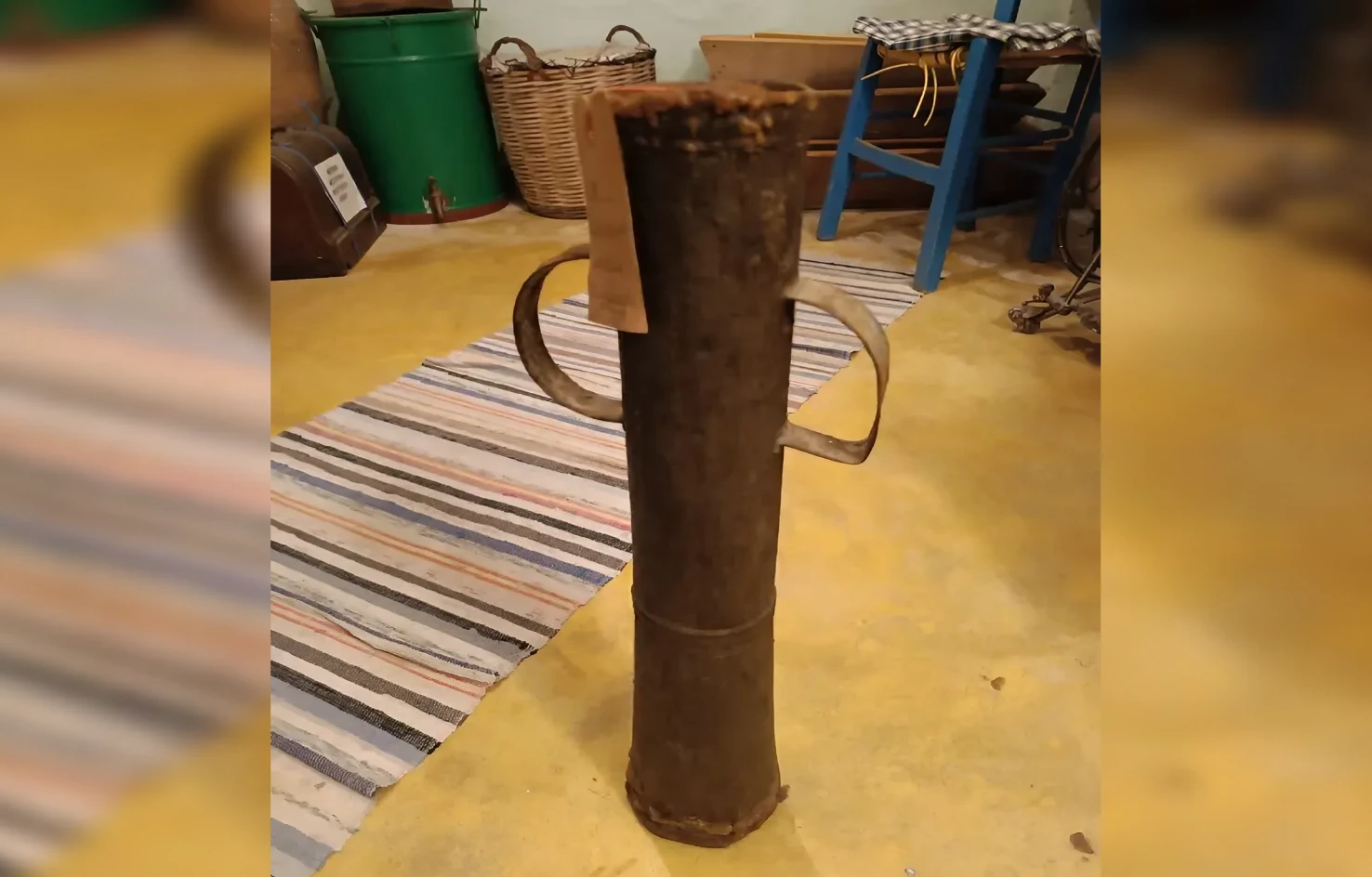 rusty cylindrical metal container with handles